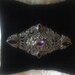 Vintage Brooch with Marcasite stones, Black Onyx cabochon inlay and Amethyst colored stone accent in the center in Sterling Silver