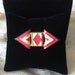 Vintage Abstract Style Womens Brooch with Ivory, Pink, and Black Enamel set in Gold Tone Metal.