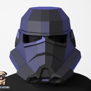 May include: A black and blue papercraft helmet with a geometric design. The helmet has a visor and a detailed faceplate.