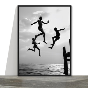 Black and white kids travel photography wall art print Cartier-Bresson-inspired of three children jumping above water in Africa (unframed)