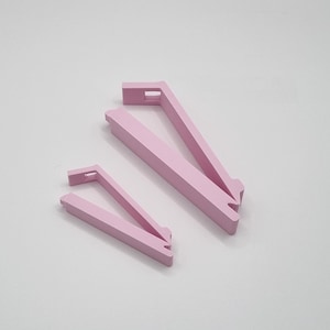 May include: Two pink plastic bag clips, one larger than the other, are shown on a white background.
