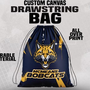 May include: Custom canvas drawstring bag with a navy blue background and a gold and white bobcat logo. The bag features the text "McMeans Bobcats" and "All Over Print". The bag is made of durable material.
