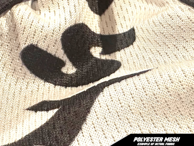May include: Close-up of a beige polyester mesh fabric with black abstract shapes. The fabric has a textured, open weave. The bottom of the image has the text "POLYESTER MESH EXAMPLE OF ACTUAL FABRIC".