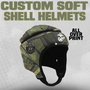 May include: A custom soft shell helmet with an all-over camouflage print. The helmet features a black interior and a chin strap. The text "CUSTOM SOFT SHELL HELMETS" is at the top. The helmet has a military emblem.