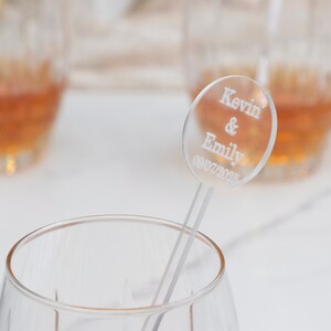 May include: Clear acrylic drink stirrer with a round disc that says "Kevin & Emily 09/07/2023".