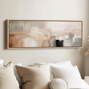 Könnte beinhalten: Abstrakter Kunstdruck in einem rechteckigen Holzrahmen. Das Kunstwerk zeigt eine Mischung aus neutralen Farben, darunter Beige, Braun, Grau und Weiß, mit sichtbaren Pinselstrichen. Der Text "Atelier Printworks." ist unten im Bild zu sehen.