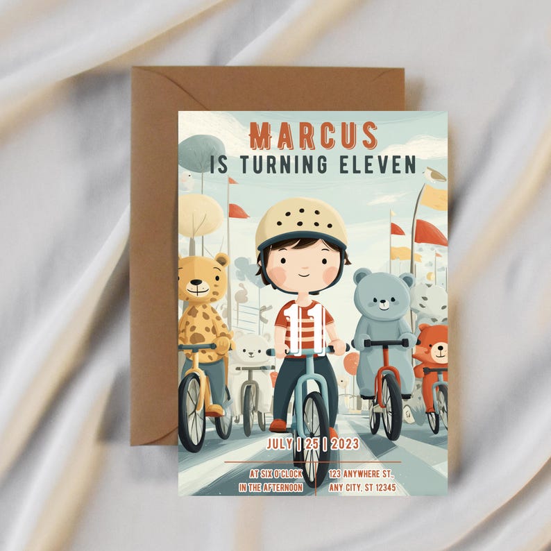 May include: An illustrated birthday invitation featuring a boy on a bicycle with teddy bear friends. The text reads "MARCUS IS TURNING ELEVEN" with the date "JULY 25 2023" and event details. The invitation is paired with a brown envelope.