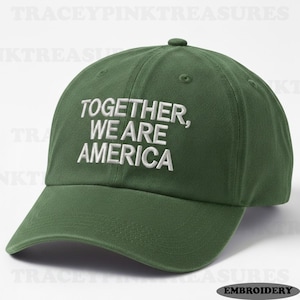 May include: A dark green baseball cap with the embroidered text "TOGETHER, WE ARE AMERICA" in white. The cap has a curved brim and a small button on top. The hat is a classic style.