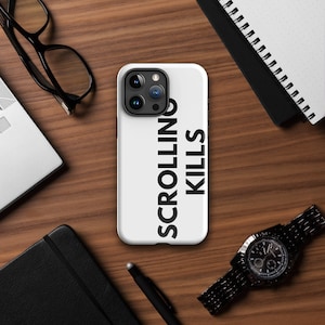 May include: White iPhone case with a black inscription that reads "Scrolling Kills".