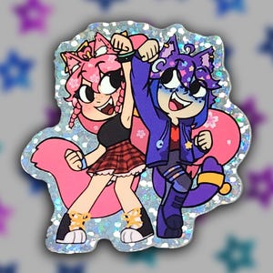 May include: A holographic sticker featuring two cartoon characters with animal ears. One character has pink hair and a plaid skirt, the other has purple hair and a blue jacket. Both are smiling and raising their arms.