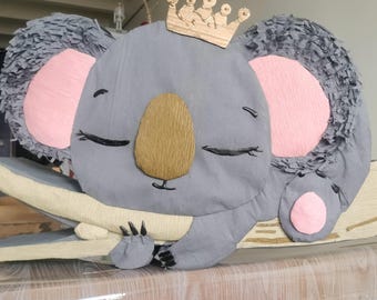 Cute koala piñata with eucalyptus leaves.