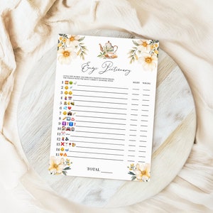 May include: A printable game card with a floral design and the title "Emojiictionary". The game requires players to guess the word represented by an emoji. The card has a list of 15 emojis and spaces to mark right or wrong answers.