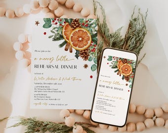 May include: A printed invitation and a smartphone displaying a similar design for a rehearsal dinner. The design features watercolor illustrations of orange slices, pinecones, and greenery. The text reads "a merry little REHEARSAL DINNER".