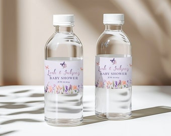 May include: Two clear plastic water bottles with labels featuring a floral design and butterflies. The labels read "Leah & Jackson's Baby Shower" with the date "June 29 2024".