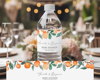 May include: Water bottle label with a watercolor design of orange blossoms and leaves. The label says "Samantha & Degenins Baby Shower May 15th 2025".