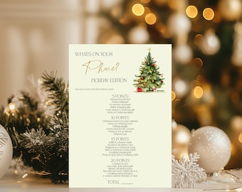 May include: A printable Christmas party game card featuring a festive green Christmas tree illustration. The card has a gold title "What's on your Phone? Holiday Edition" and a list of items to check on your phone for points. The game is for the guest with the most points wins.