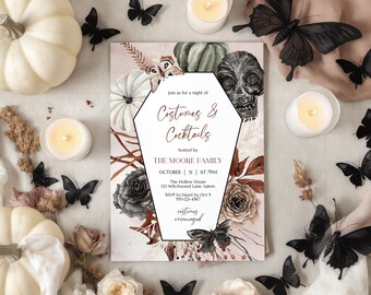May include: A Halloween-themed invitation with the text "Costumes & Cocktails" in a coffin-shaped frame. The design includes pumpkins, a skull, flowers, and black butterflies. Candles and decorative elements surround the invitation.