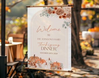 May include: A welcome sign for a Thanksgiving dinner with a watercolor design of fall leaves, pumpkins, and flowers. The sign reads "Welcome to the Johnson's Family Thanksgiving Dinner, November 28th, 2024".