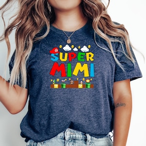 May include: A navy blue t-shirt with a graphic of a video game character and the text "SUPER MIMI" in colorful letters.