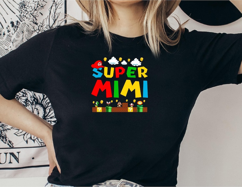May include: Black t-shirt with a colorful graphic of a video game character with the text "SUPER MIMI" on it.
