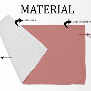 May include: A pink polyester towel with a white cotton backing. The front side is fade-resistant and features the text "Printed side 100% Polyester". The back side is white and features the text "White Back". The towel is folded in half and the inside is labelled "Inside 100% Cotton".
