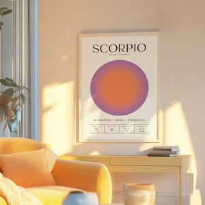 May include: A framed art print featuring the word "SCORPIO" above a gradient circle in shades of purple and orange. The print includes the dates October 23 - November 21 and the words "DETERMINED BRAVE PASSIONATE".
