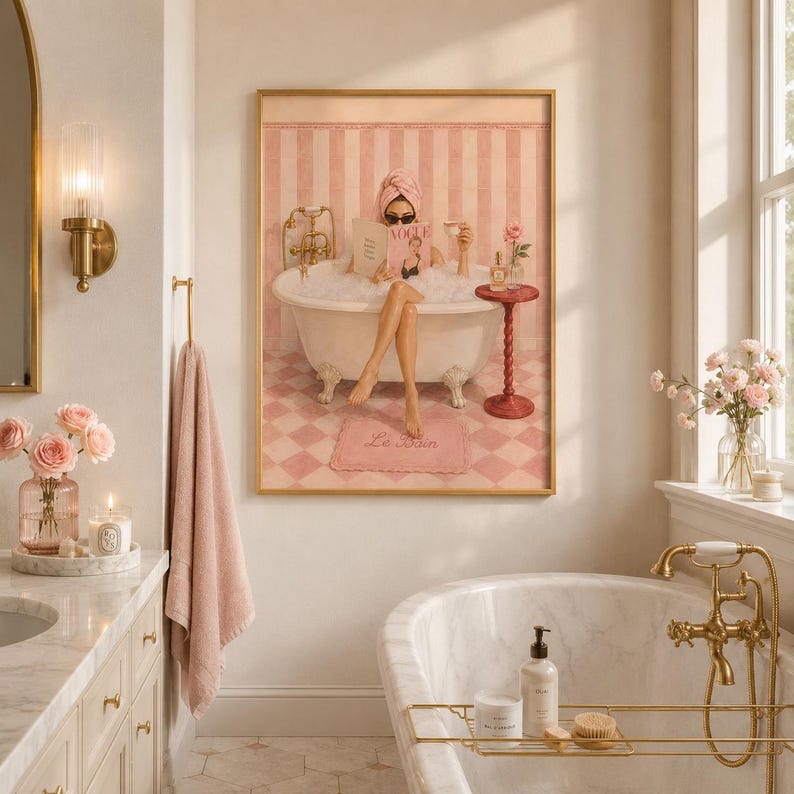 May include: A framed wall art print depicting a person in a clawfoot bathtub filled with bubbles, reading a magazine titled Vogue. The scene features pink striped walls, a checkered floor, and a small side table with a rose in a glass vase.