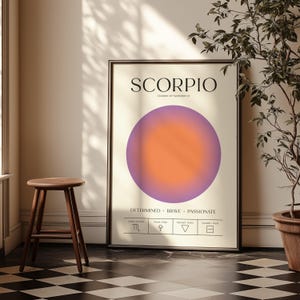 May include: Framed Scorpio zodiac sign art print. The poster features the word "SCORPIO" at the top, with the dates October 23 - November 21 below. A purple and orange gradient circle is in the center. The bottom has the words "DETERMINED BRAVE PASSIONATE".