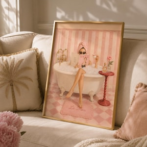 May include: A framed wall art print depicting a person in a clawfoot bathtub filled with bubbles, wearing a pink towel wrap and sunglasses, reading a magazine titled Vogue. The scene features pink striped walls, a checkered floor, and a pink rug with the text Le Bain.
