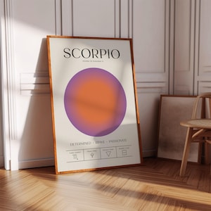 May include: A framed art print featuring the word "SCORPIO" above a gradient circle in purple and orange. The print includes the text "October 23 - November 21" and the words "DETERMINED BRAVE PASSIONATE".