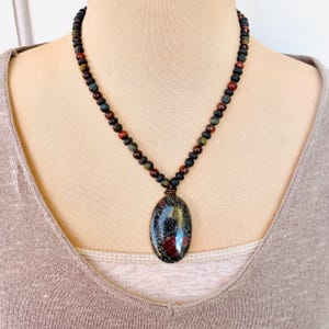 May include: A set of three ceramic mugs with a speckled, matte finish. The mugs are in shades of cream, light gray, and dark gray. Each mug has a simple, minimalist design and a rounded handle. Perfect for coffee or tea.