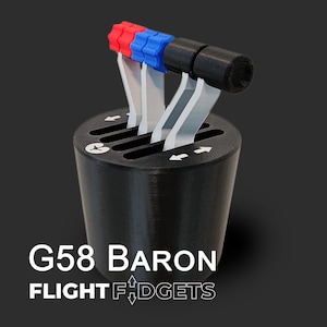 May include: A black G58 Baron flight control lever with red, blue, and black accents. The lever has white levers and the text "G58 BARON FLIGHT F:DGETS" is printed on the base.
