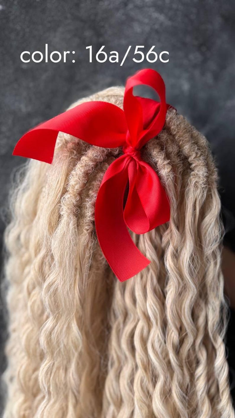 May include: A close-up of a blonde hair extension with a red ribbon tied in a bow. The hair is in a wavy style. The text "color: 16a/56c" is visible in the image.