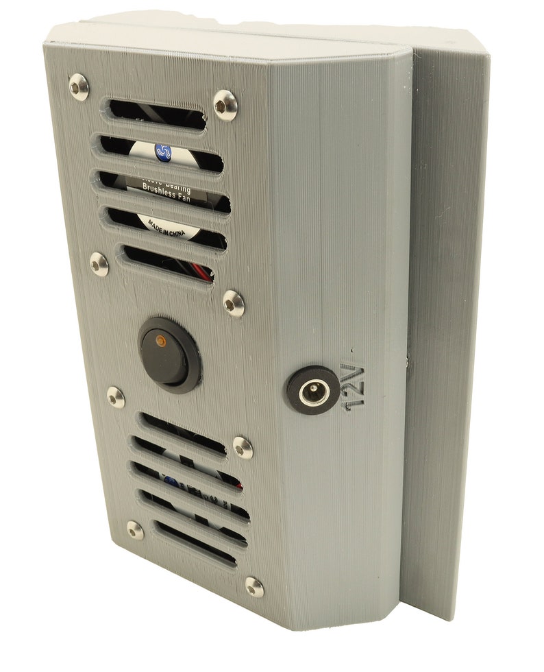May include: A grey 3D printed box with a black switch, a power cord, and a small fan with a black grill. The fan has a white label that reads "Sleeve Bearing Brushless Fan Made in China". The box has a label that reads "12V".