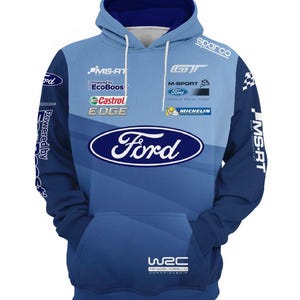 May include: A blue Ford hoodie with a hood and front pocket. The hoodie features the Ford logo, sponsor logos, and the text "MS-RT" and "WRC". The design incorporates shades of blue and white.