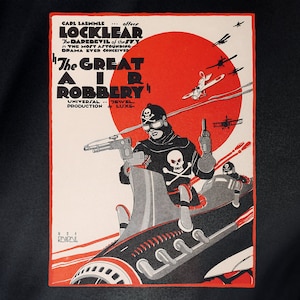 May include: A vintage movie poster for the film "The Great Air Robbery" featuring a masked man in a black suit and a skull and crossbones emblem, holding a gun and driving a futuristic vehicle against a red sun and a sky filled with airplanes.