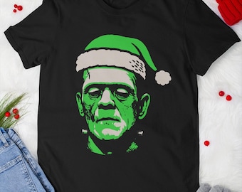 Frankenstein Christmas T-Shirt, Funny Holiday Horror Tee, Santa Hat Monster Shirt, Gothic Xmas Gift, Unisex Halloween Christmas Apparel