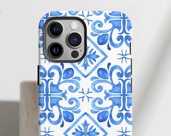 May include: A smartphone case featuring a repeating blue and white pattern of watercolor-style floral motifs and geometric diamond shapes. The design covers the entire back of the case, including the area around the triple-lens camera cutout.
