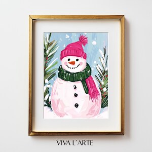 May include: A pink and green snowman with a pink hat and scarf standing in a snowy winter scene. The background is a light blue with white snowflakes.