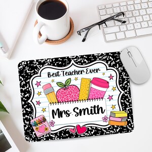 May include: A rectangular mouse pad featuring a black and white composition notebook pattern border. The center displays a white lined paper design with the text Best Teacher Ever and Mrs. Smith, decorated with a pencil, apple, ruler, and cup.