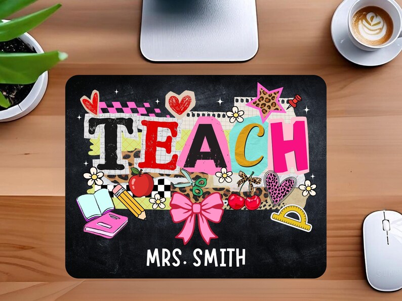 May include: Black rectangular mousepad with the word "TEACH" in colorful letters, decorated with school-themed graphics like hearts, apples, and a pink bow. The name "MRS. SMITH" is printed below.