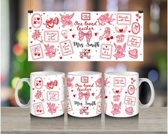 May include: White ceramic mugs and a banner featuring a pink and red teacher-themed design. The design includes cherubs, hearts, bows, and the text "One loved teacher" and "Mrs. Smith". The mugs are decorated with the same pattern.
