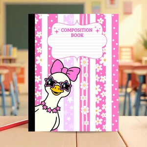 May include: A composition book with a pink and white striped cover featuring a white duck wearing a pink bow, star-shaped sunglasses, and a star necklace. The cover includes a white label area with the text COMPOSITION BOOK in pink letters.