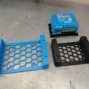 May include: A blue solar charge controller with the text "MPPT 100|20 B" and two honeycomb-patterned mounting brackets, one blue and one black. The controller has multiple connection ports and a QR code.