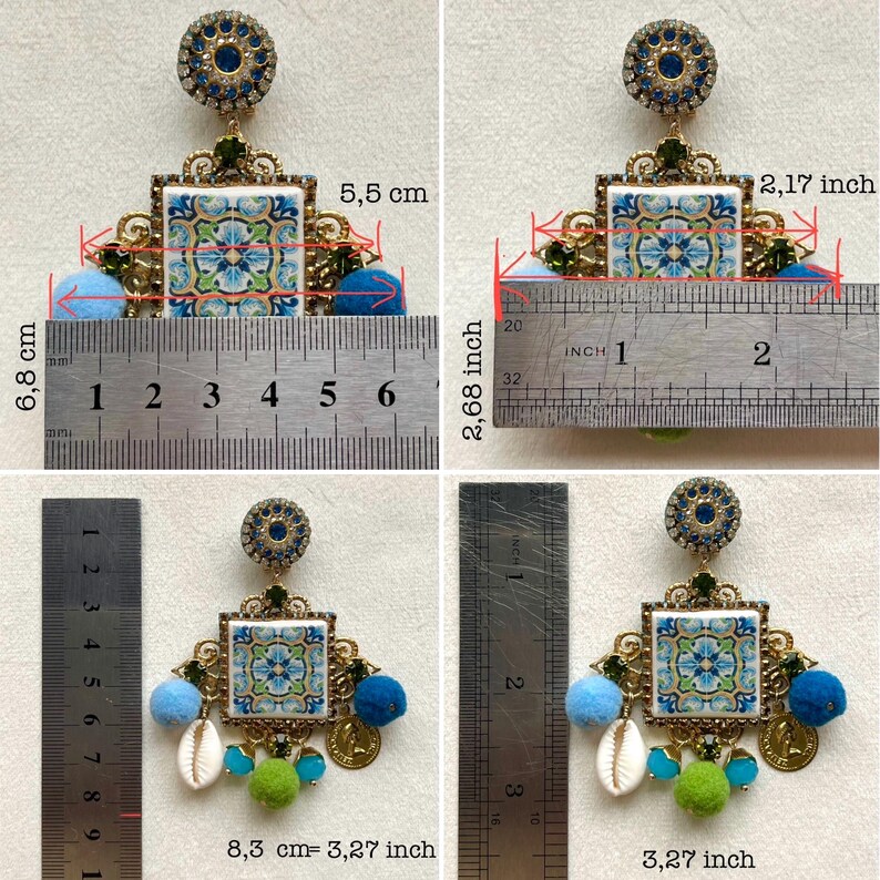 May include: A pair of blue and green ceramic tile earrings with gold accents and blue pom-poms. The earrings measure 2.68 inches in length and 2.17 inches in width. The tile is 1.77 inches wide and 1.77 inches tall.