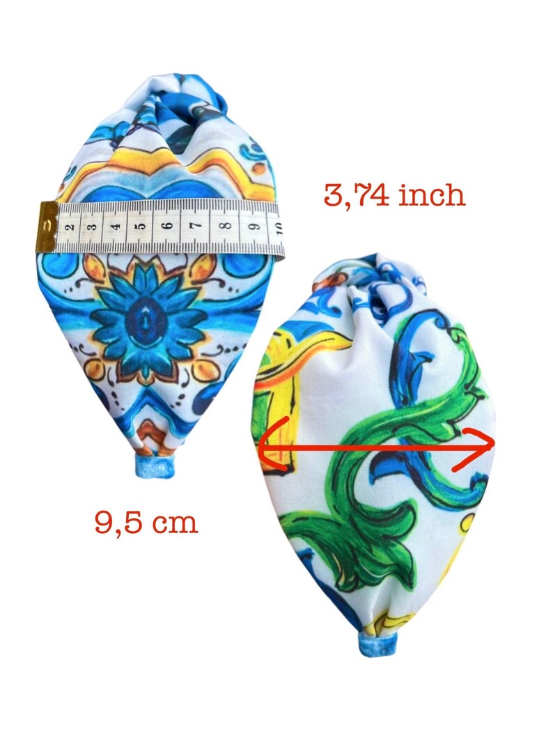 May include: Two fabric pouches with a colorful floral pattern. The pouch on the left is measured with a tape measure, showing a width of 9.5 cm. The pouch on the right is measured with a red line, showing a width of 3.74 inches.