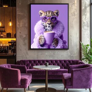 May include: A framed wall art print featuring a leopard wearing purple sunglasses and a matching purple faux fur coat, holding a purple coffee mug. The leopard is centred against a solid purple background, showcasing detailed fur and facial features.