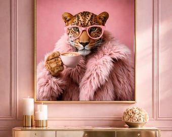May include: A framed print of a leopard wearing pink glasses and a pink faux fur coat, holding a cup of coffee. The artwork is set against a pink background, with a gold frame. The image has a whimsical and stylish theme.