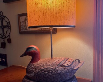 vintage green-winged teal ceramic duck table lamp featuring a textured burlap-style oval shade