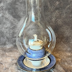 decorative studio pottery oil lamp, featuring a handcrafted ceramic base and a clear glass chimney